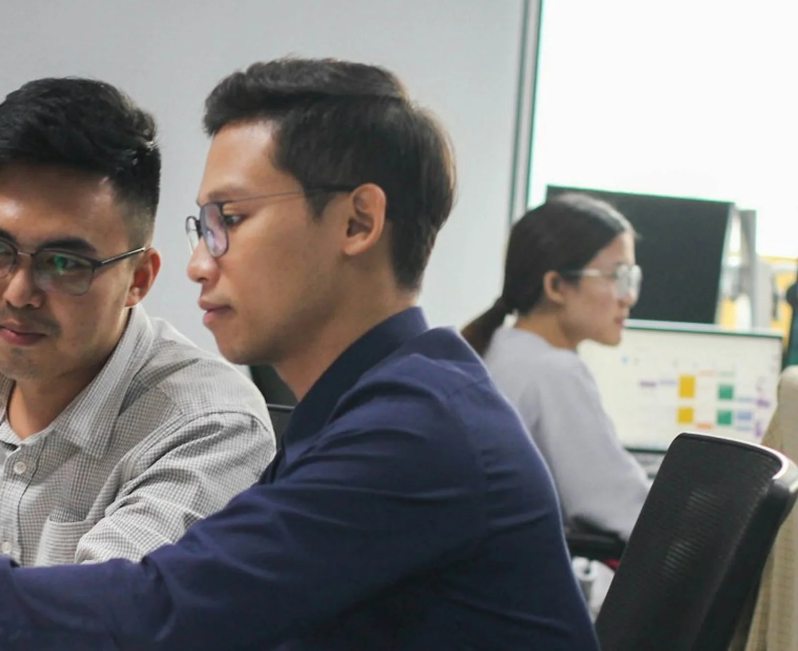 A sourcing team reviewing options together in an office